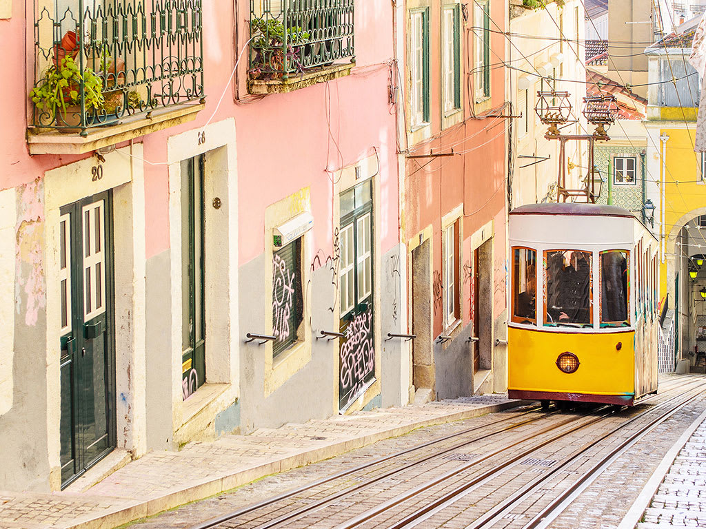 Trolley going up a street.