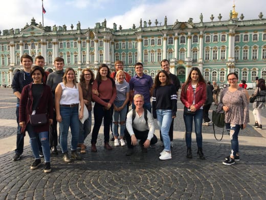 A group of students outside a building in Russia.