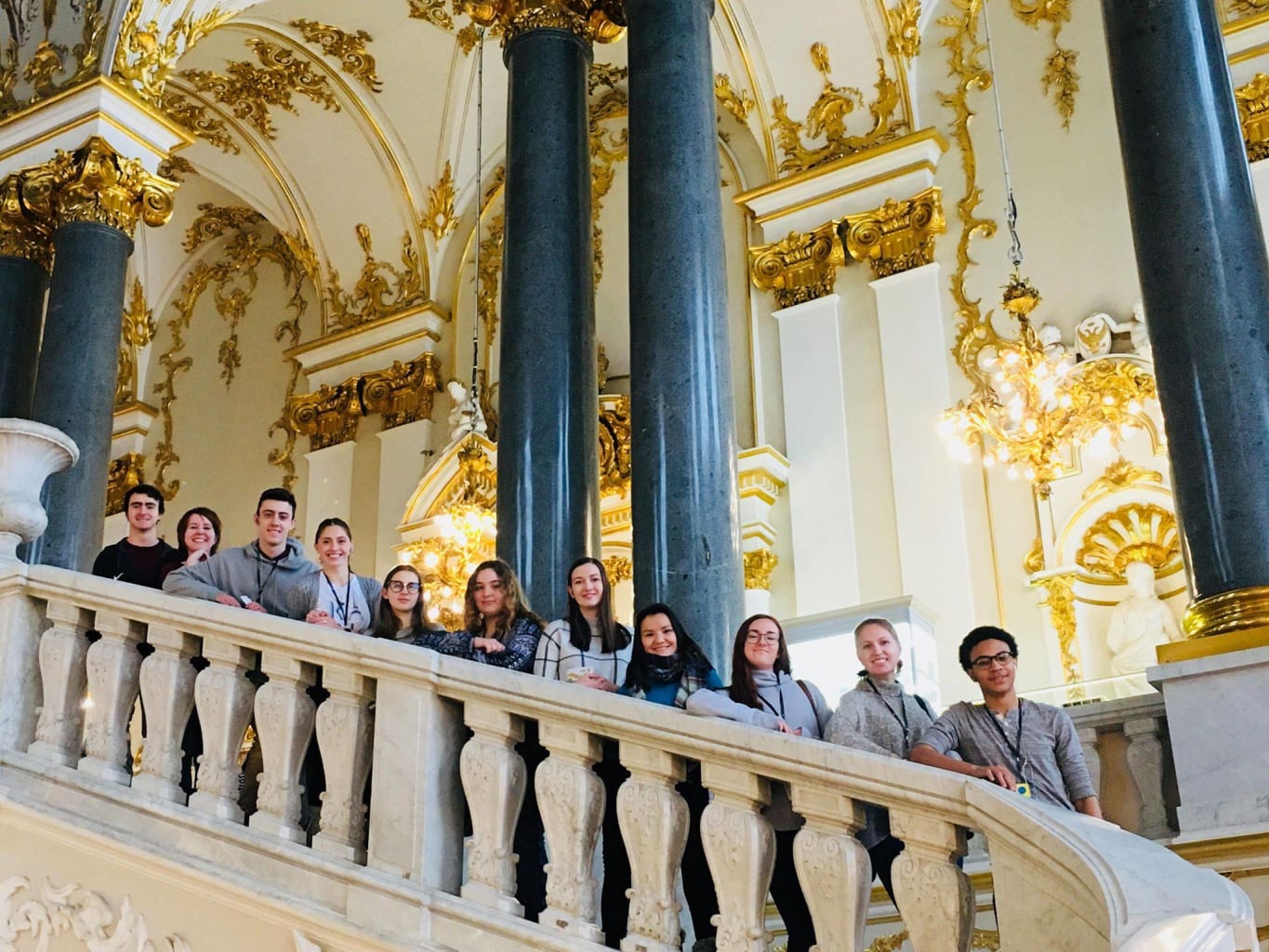 People posing on staircase.