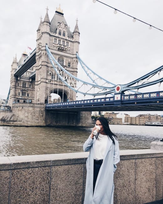 A student standing in front of Tower Bridge.