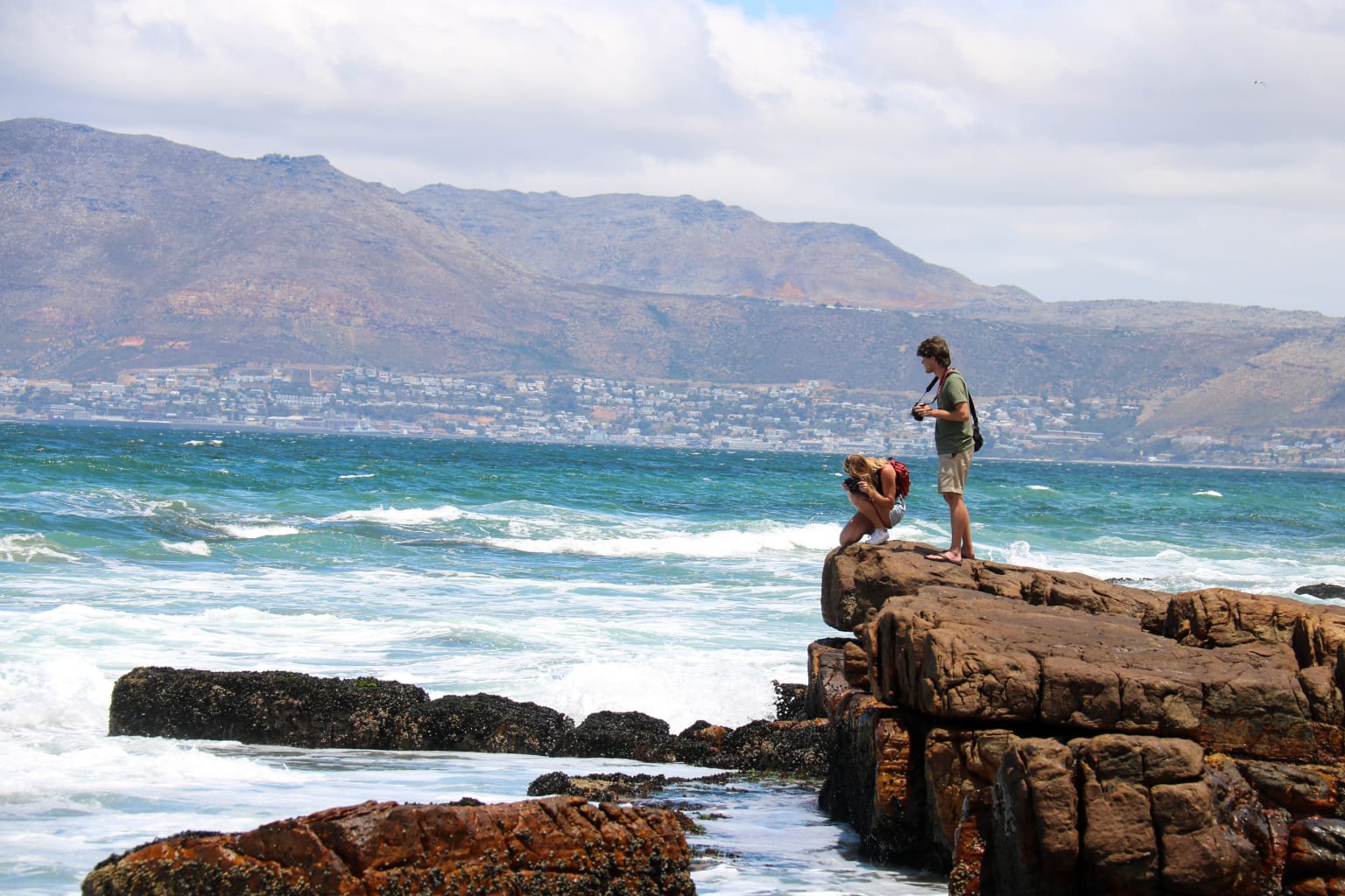 People taking pictures on rocks.