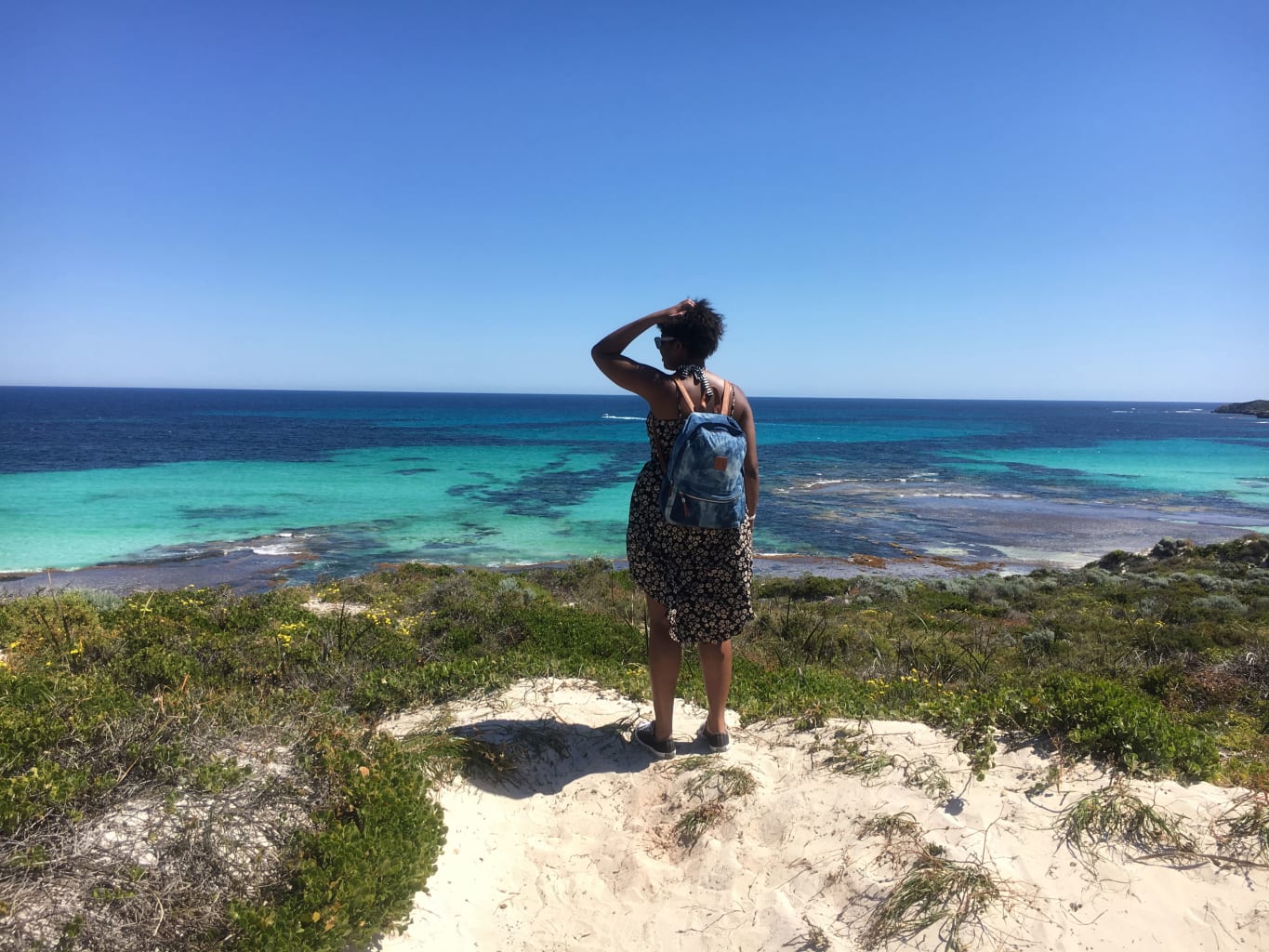 Woman standing and looking out at the ocean in Perth.