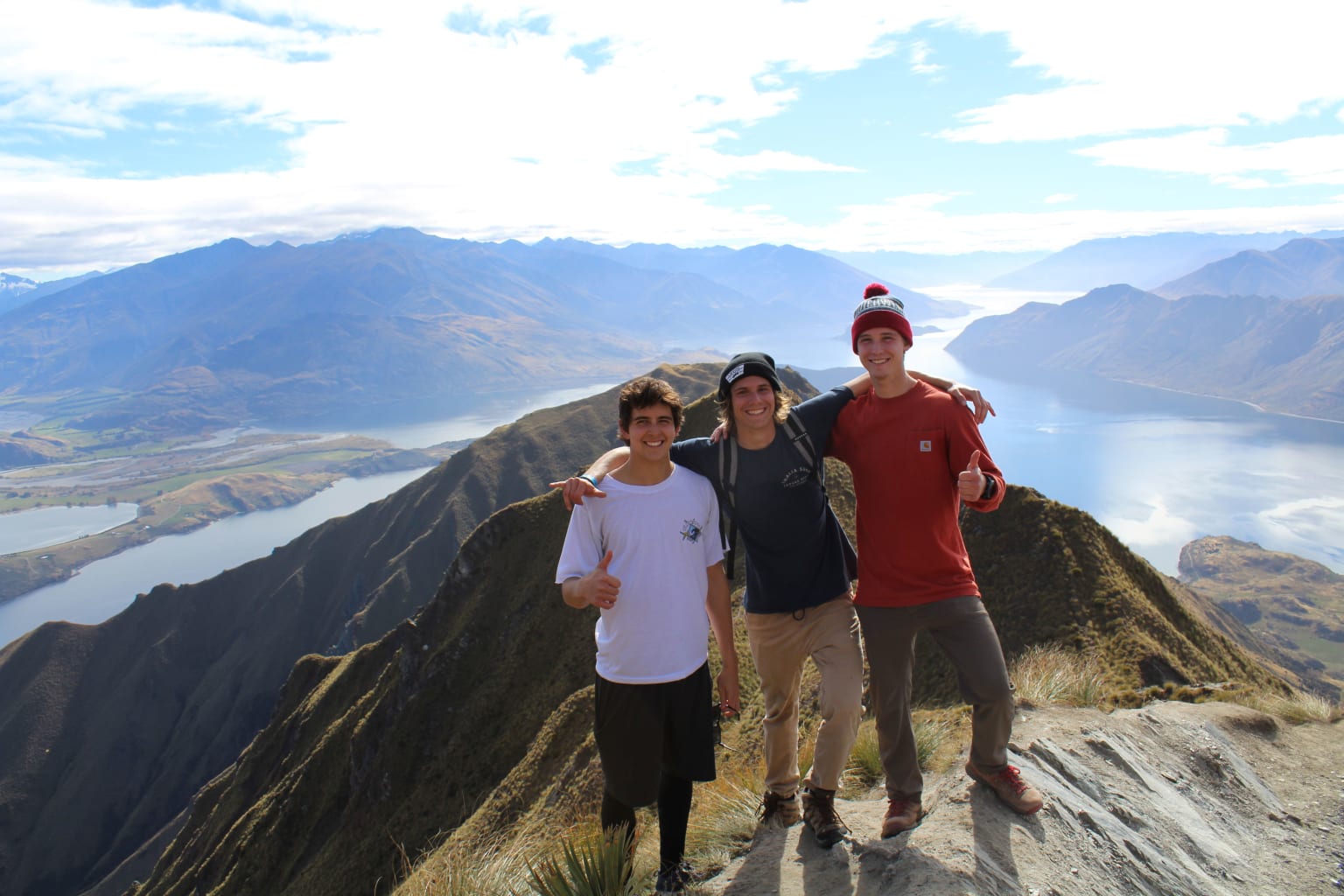 People posing on cliff.