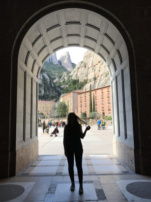 Girl silhouette under arch.