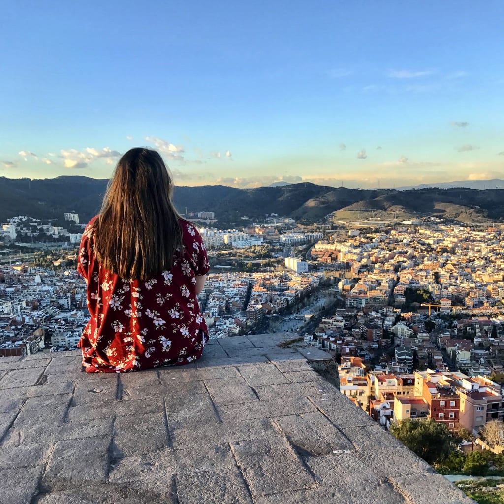 Girl sitting on stones.