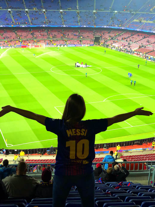 Girl in jersey at soccer game.