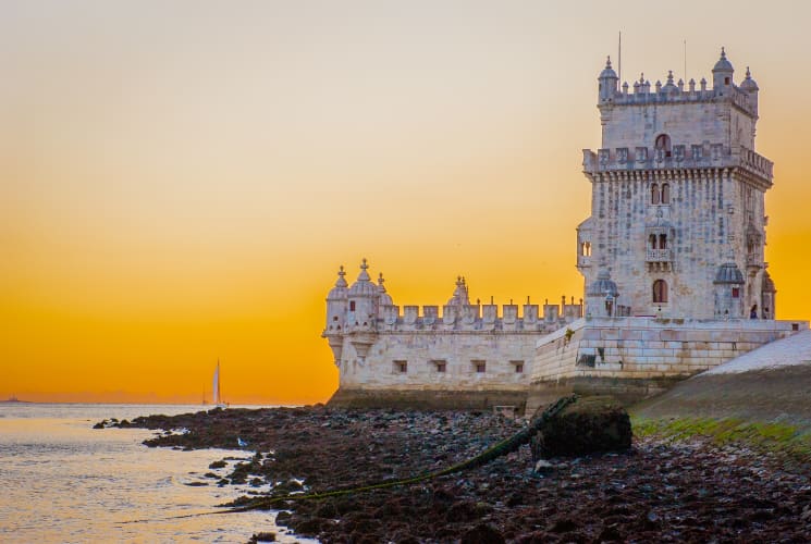 Belém Tower with a sunset in the background.