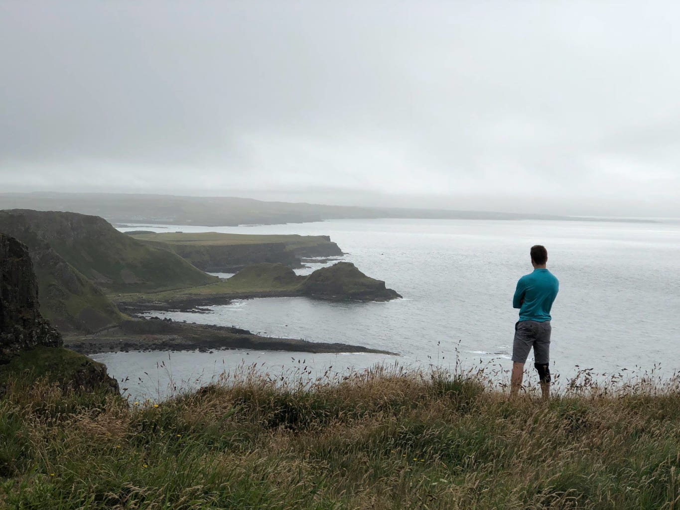 Man standing on the cliffs in Maynooth, Ireland.