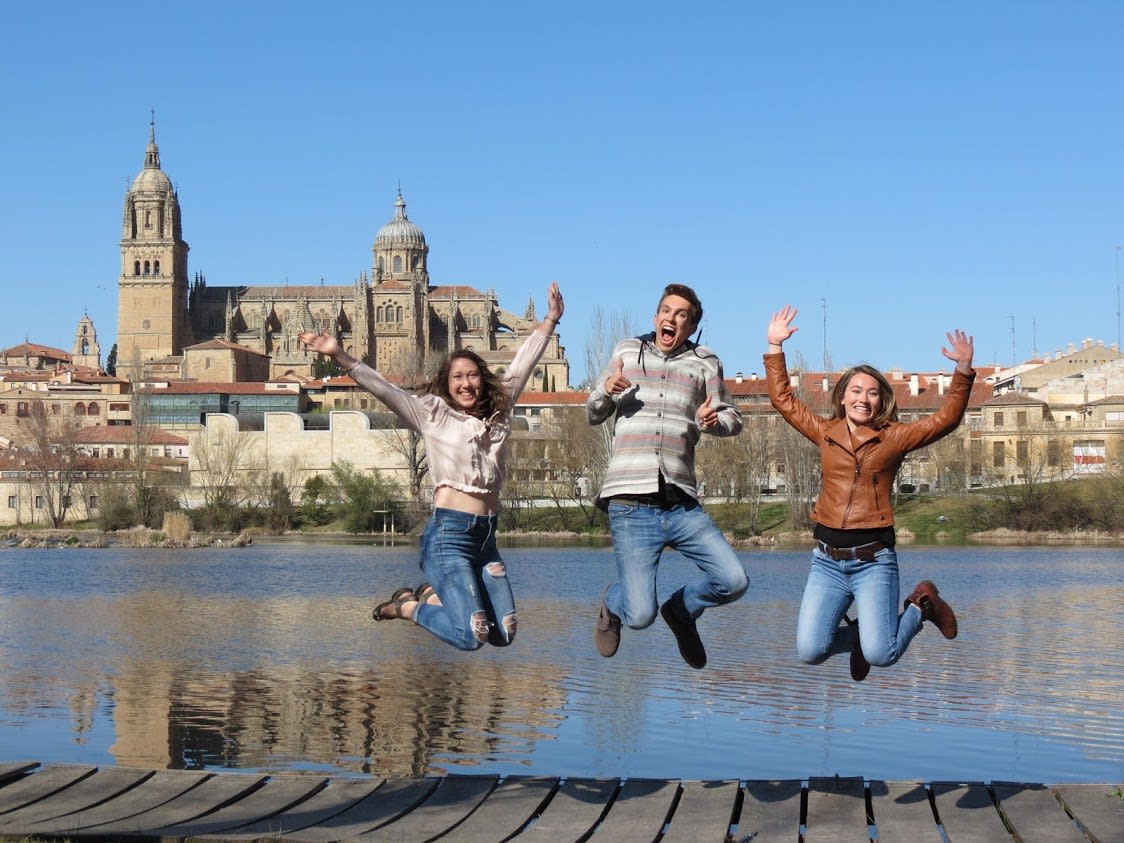 Three kids jumping in air.