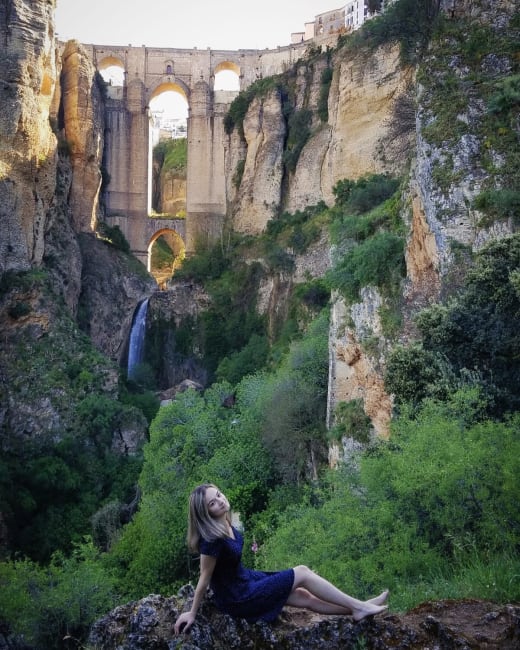 Girl posing in front of arches.