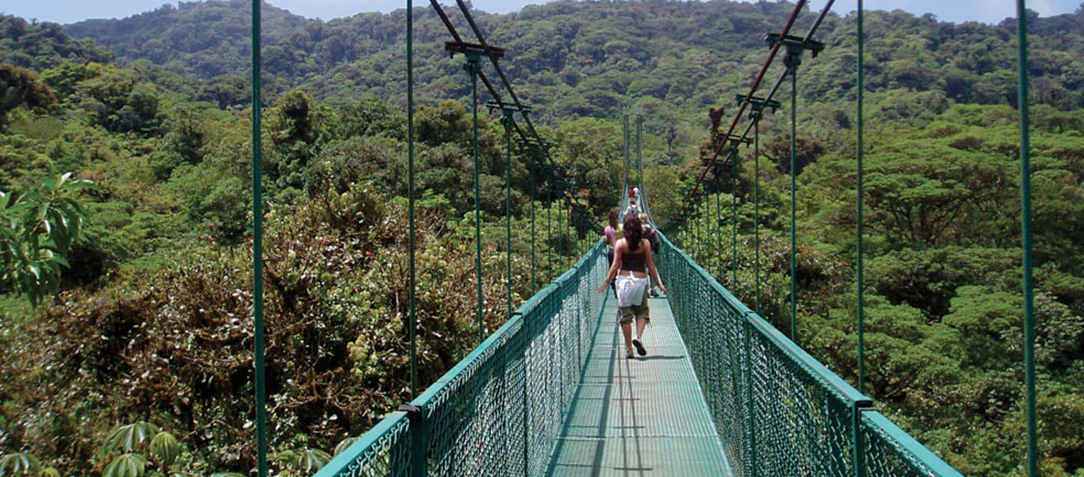 Students walking across suspension bridge in Costa Rica.