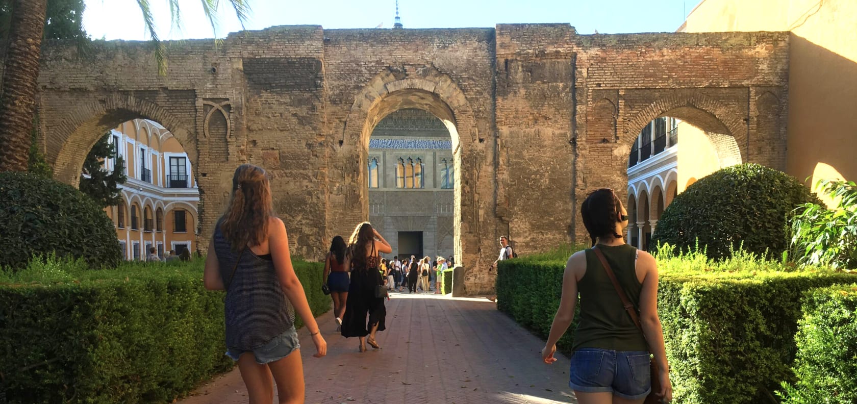 Girls walking under arch.