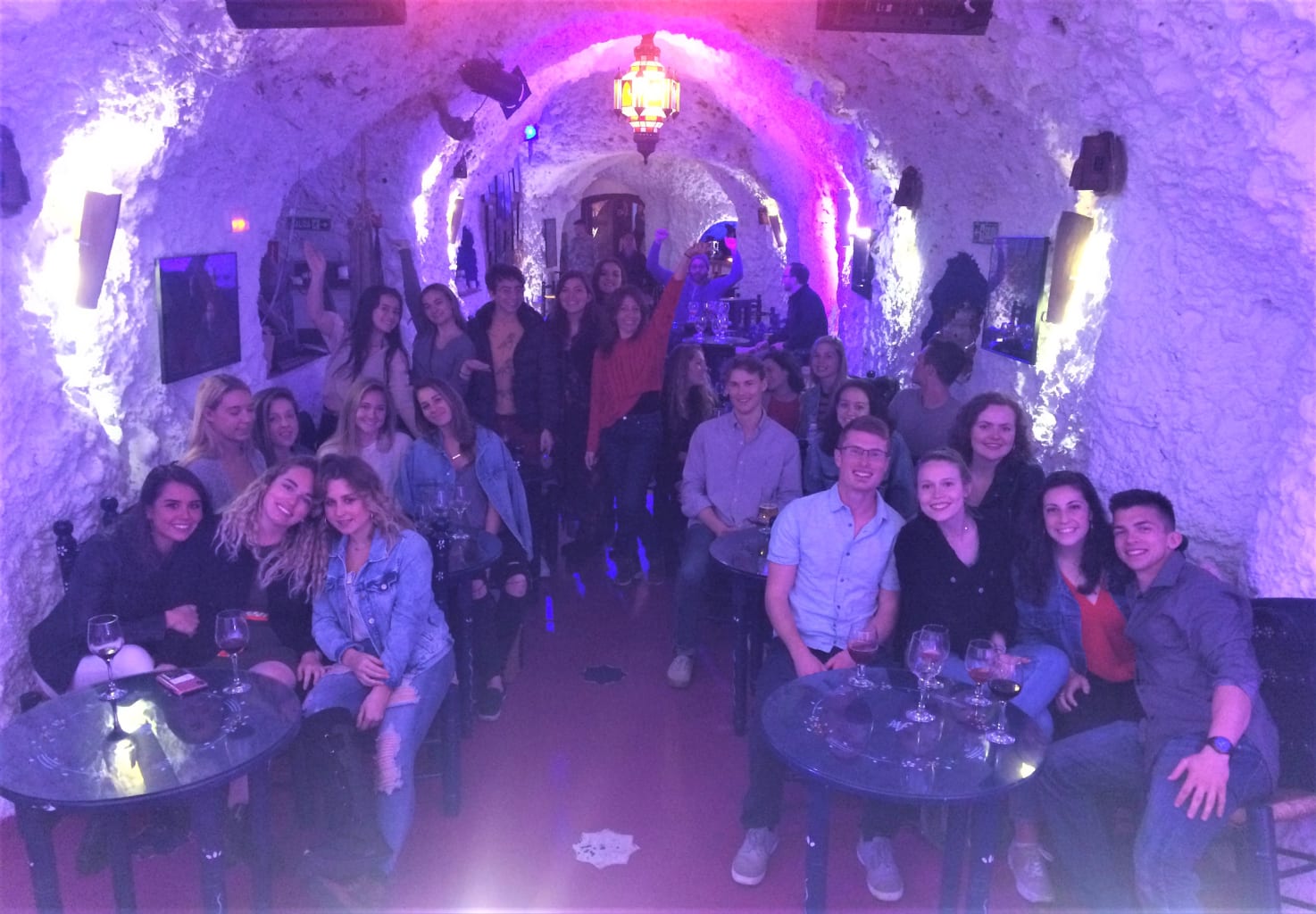 Group posing in purple light.