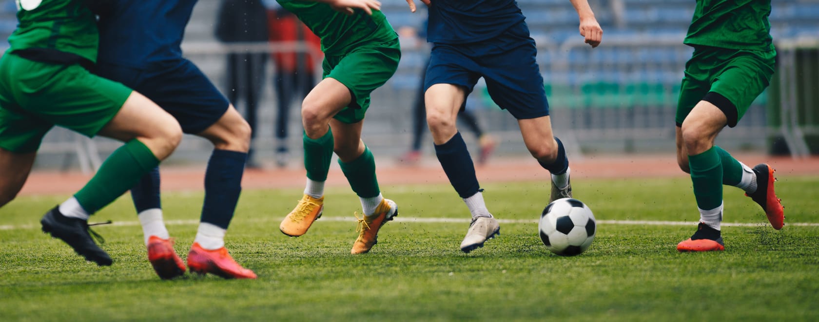 Soccer players kicking a soccer ball during a match.