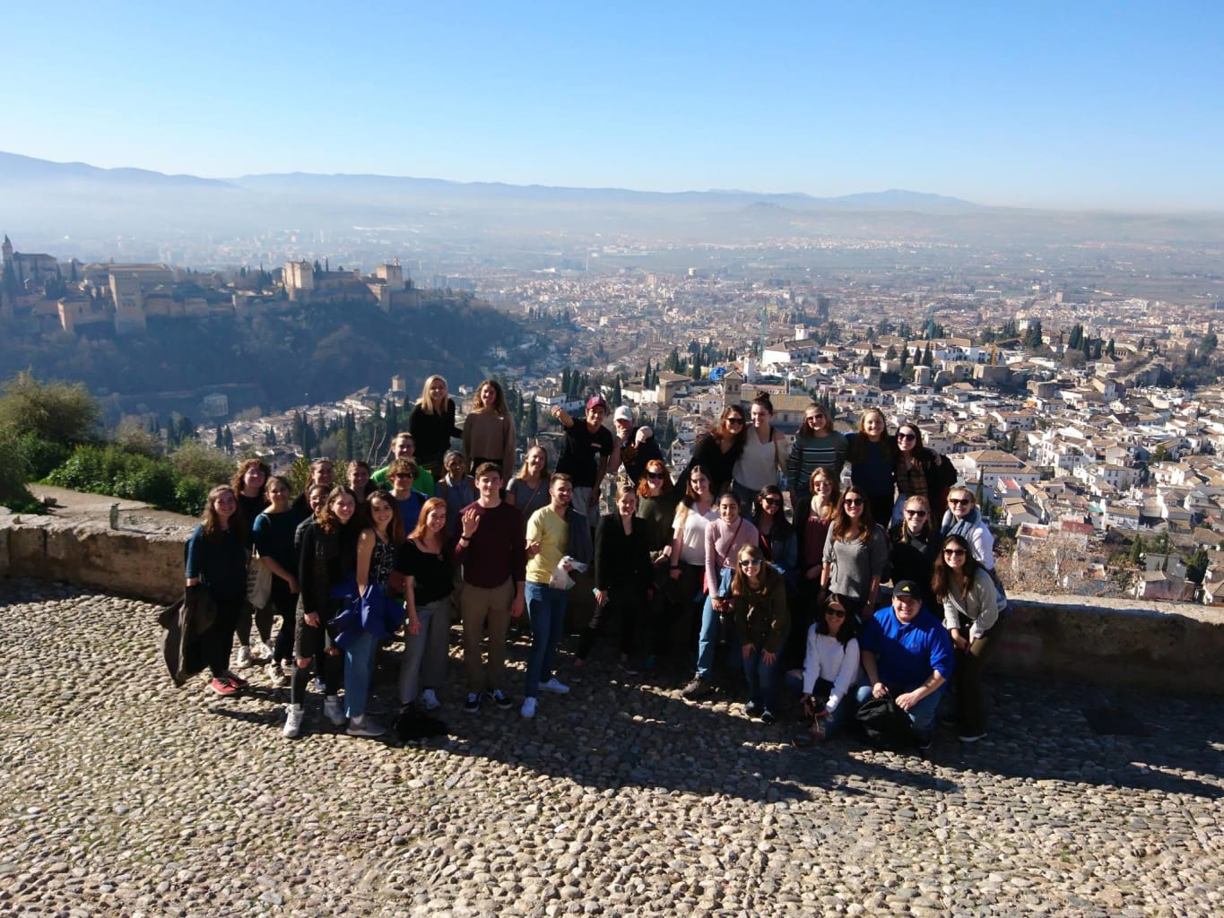 Group posing on cliff.