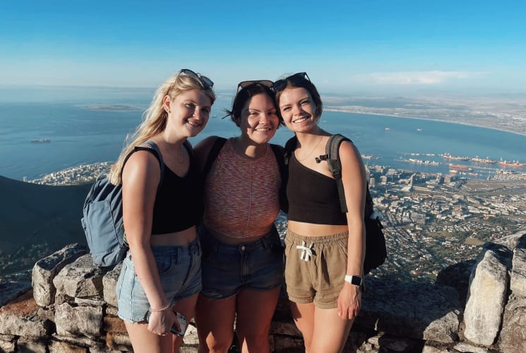 Girls posing on mountain.