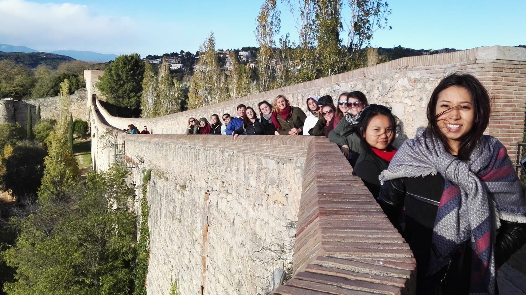 People walking on path on ledge.