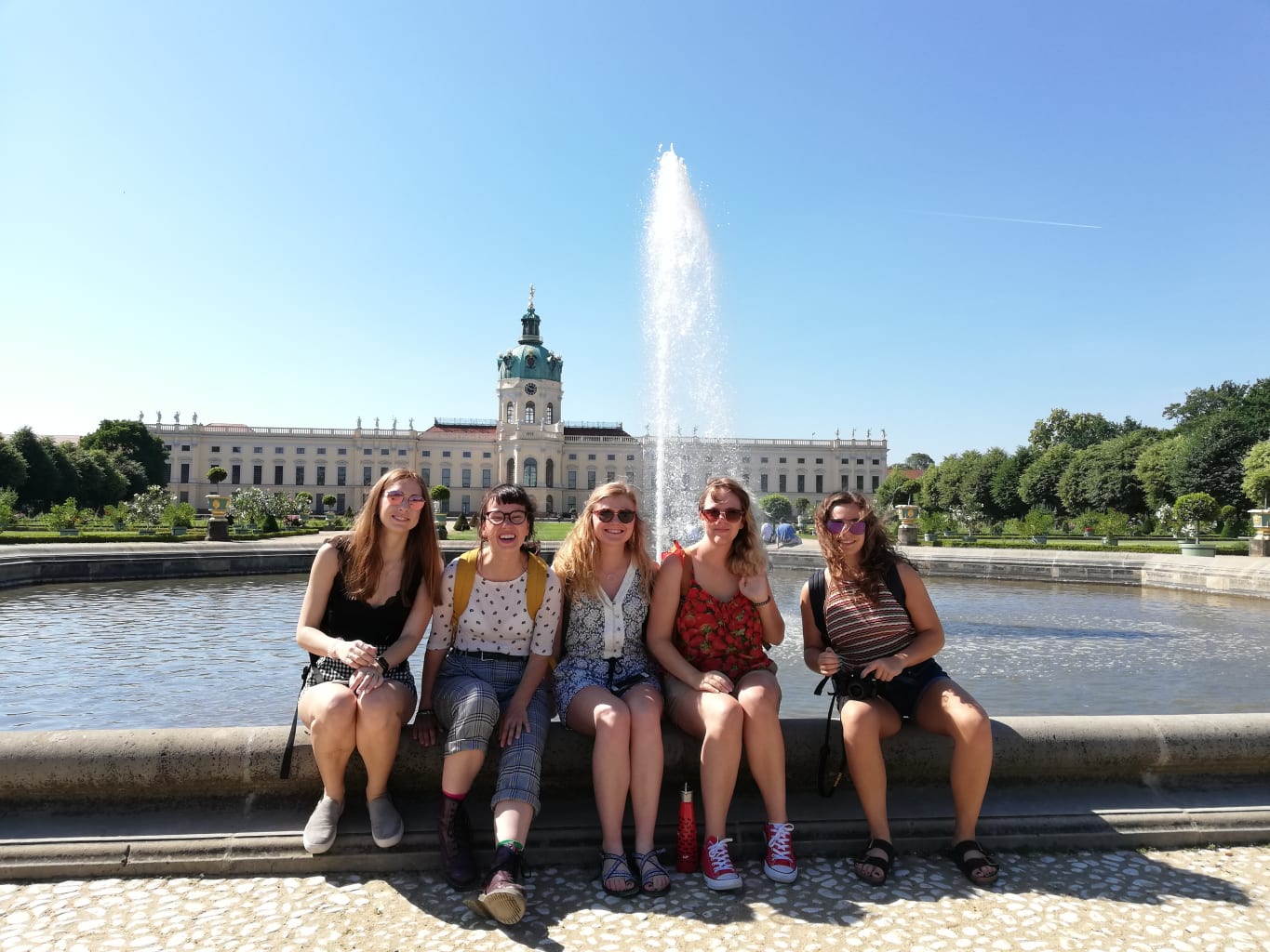 People sitting on fountain.