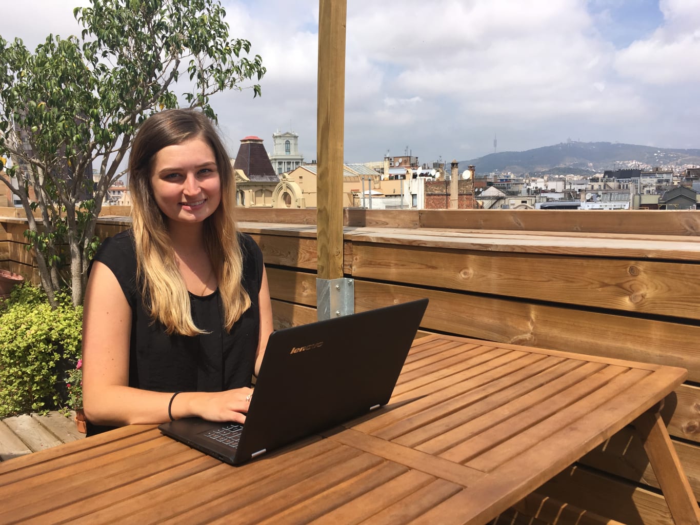 A student working with a laptop outside.