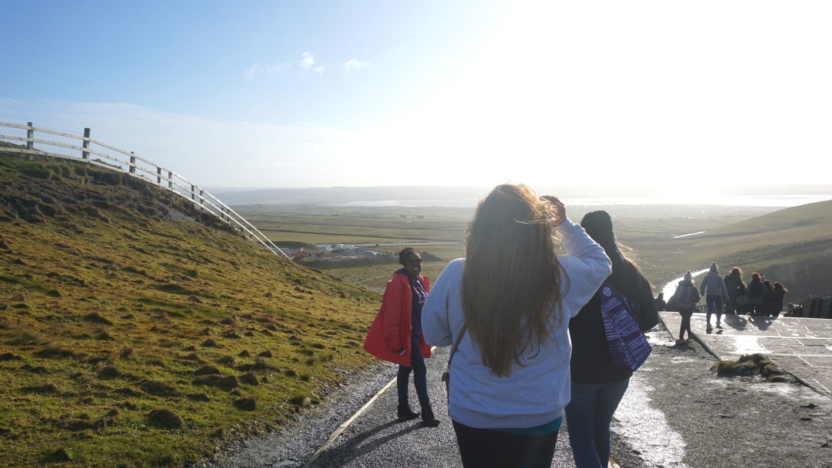 Girls walking down road.