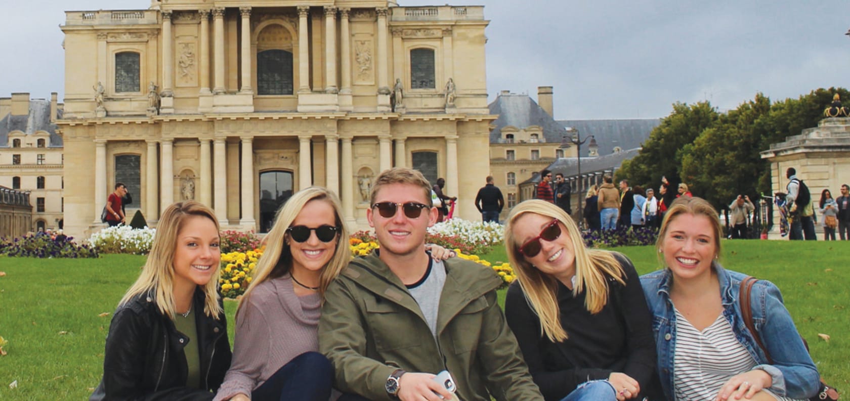 Five people sitting smiling.