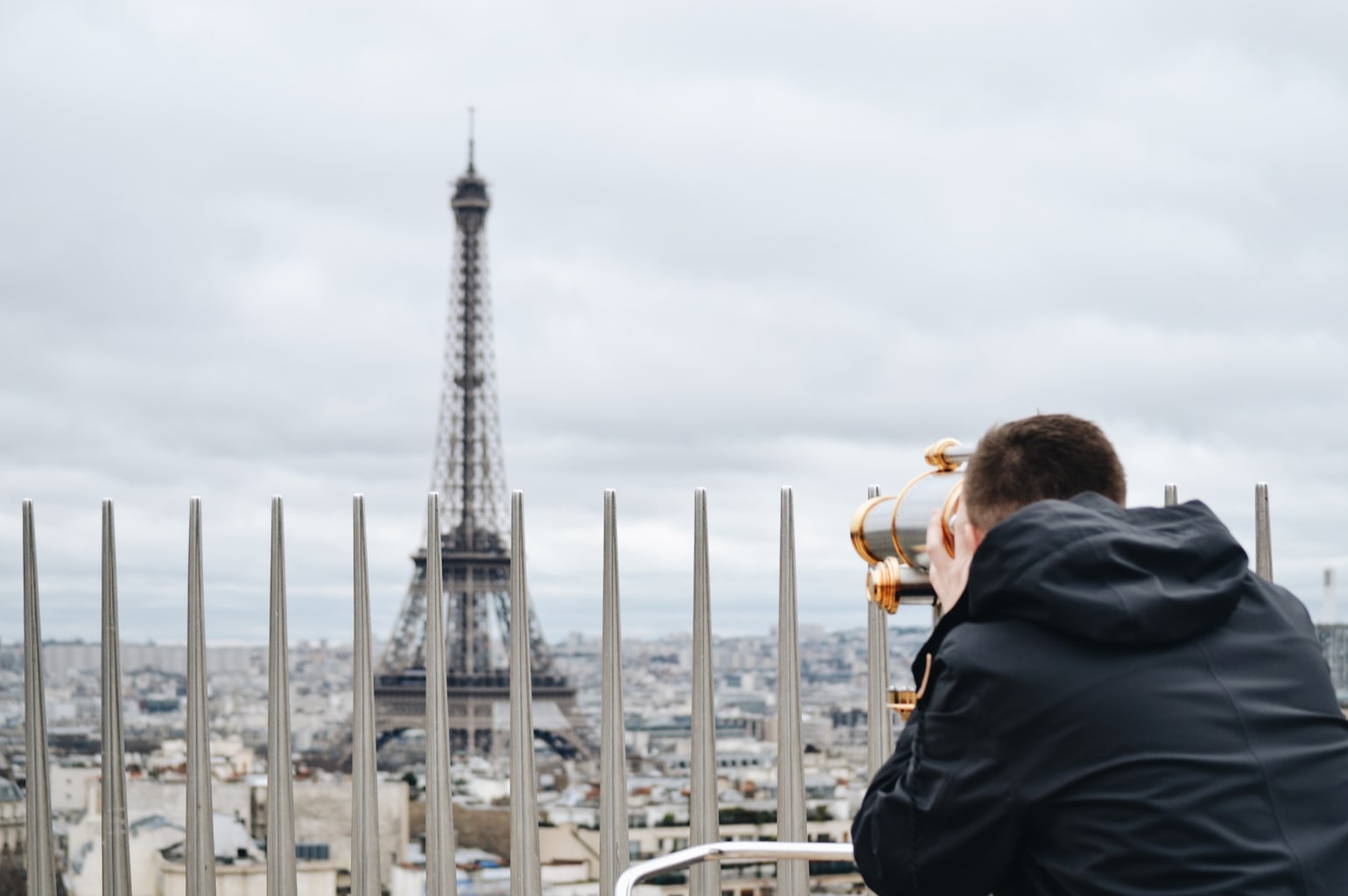 A student viewing the Eiffel Tower from afar.