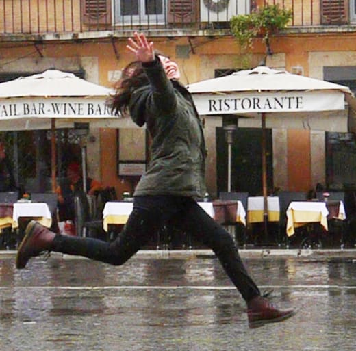 AIFS Abroad student running down a street in Rome, Italy.