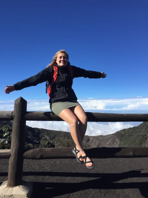 A student sitting on a fence.