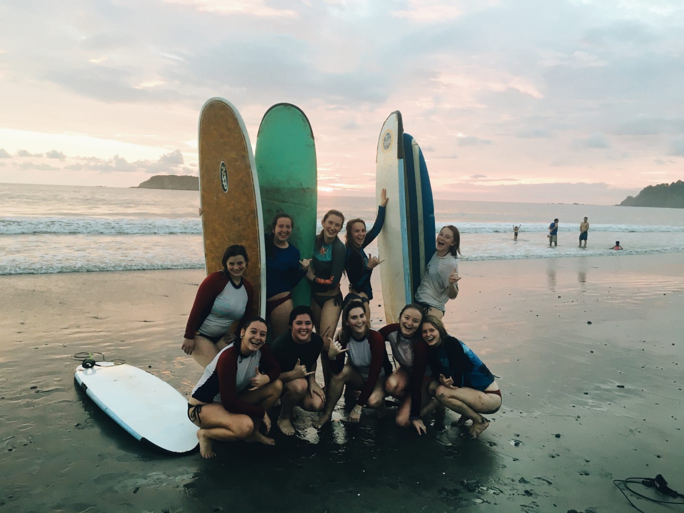 People with surfboards smiling.