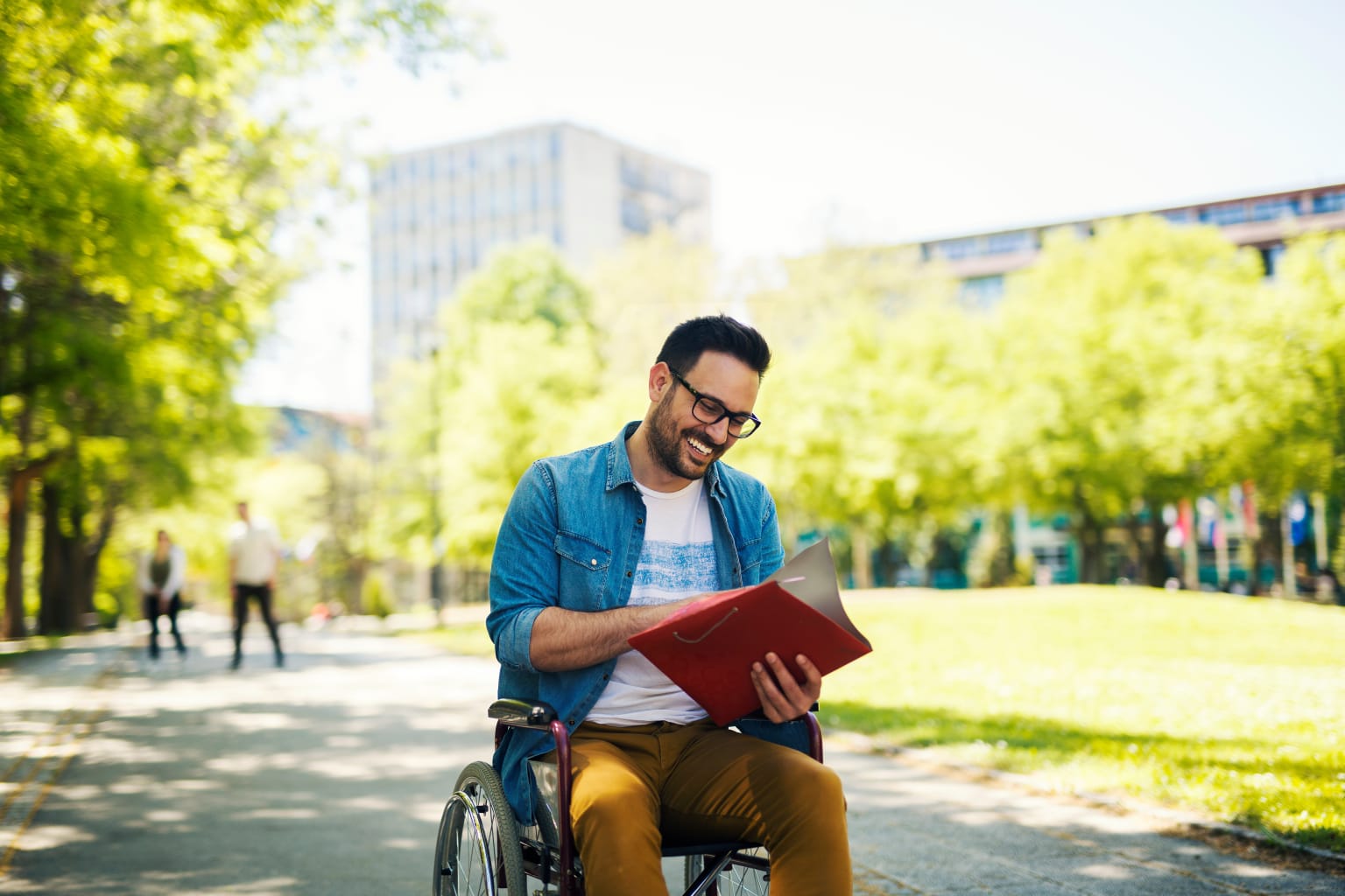 College student operates wheelchair on campus.