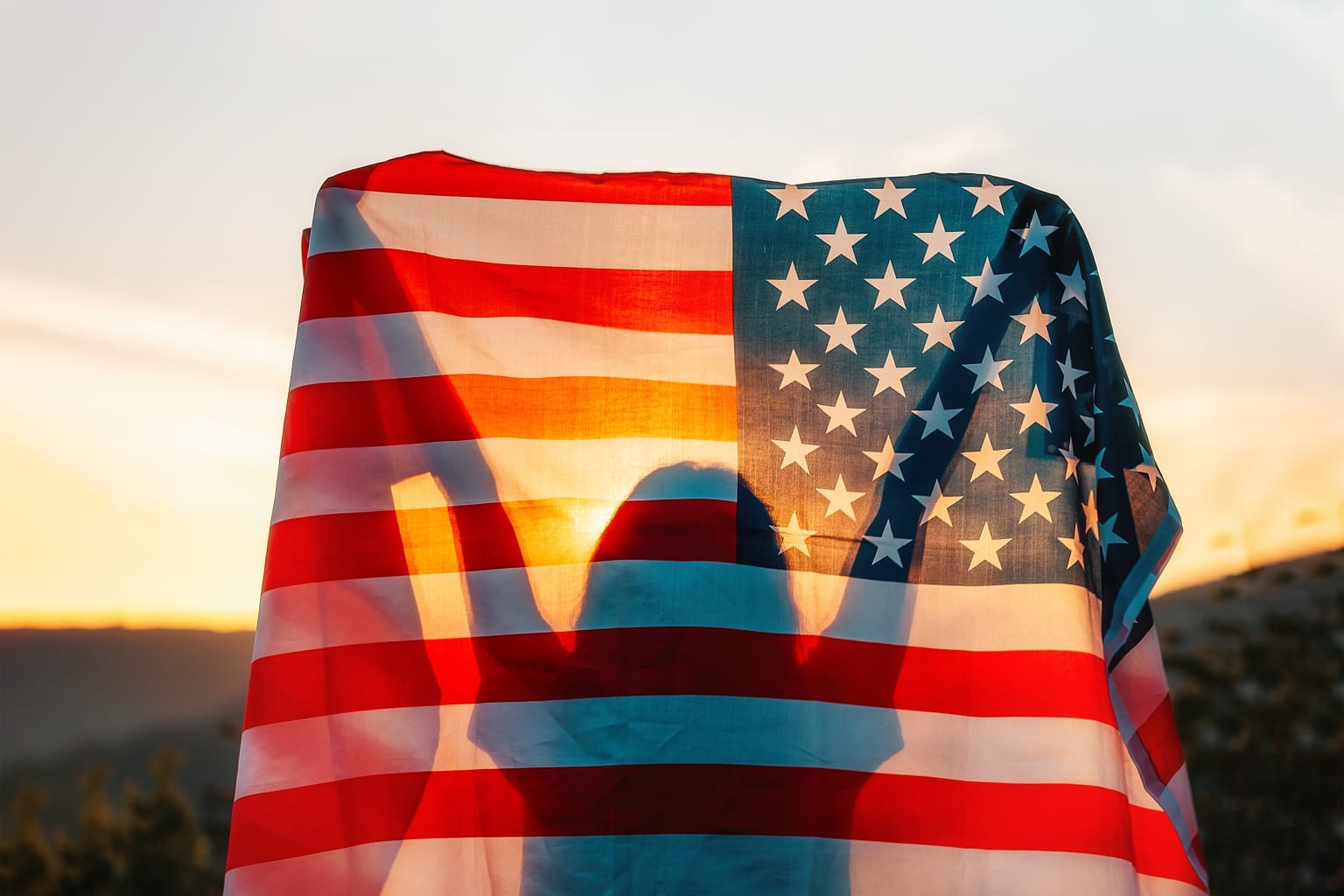 Woman holding up American flag.