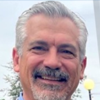 A headshot of John Stame, IT Leader